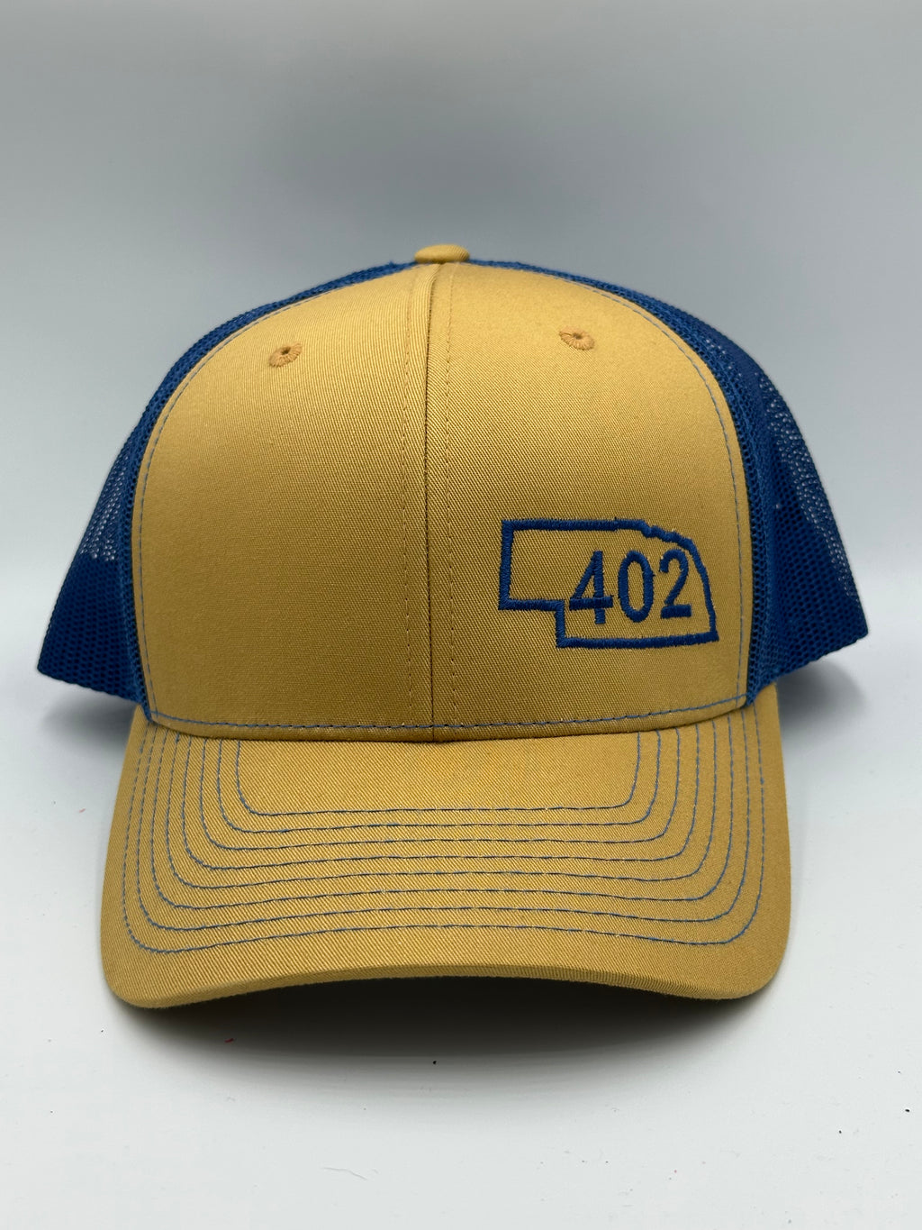 Nebraska 402 Trucker Hat Blue and Gold