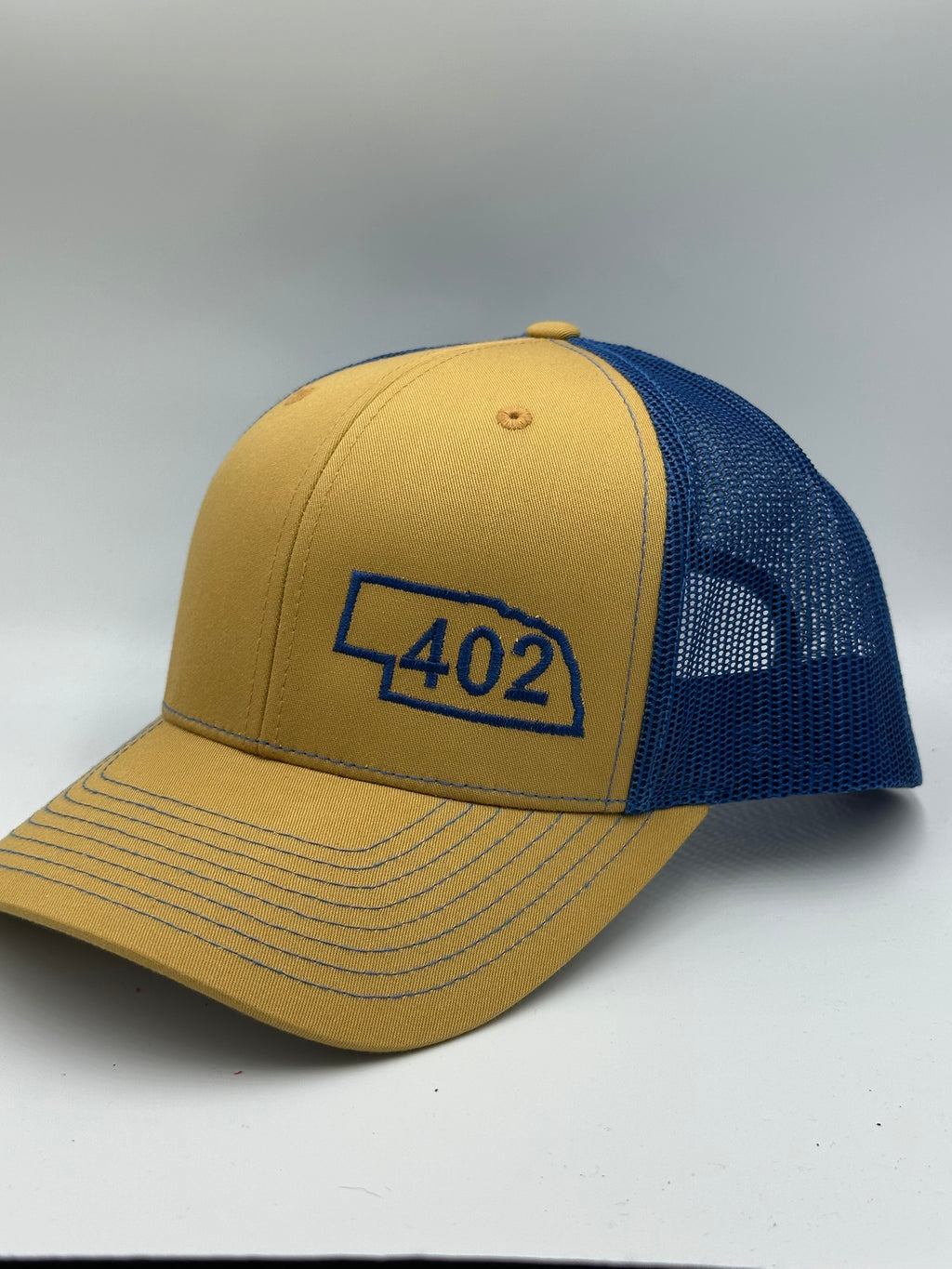Nebraska 402 Trucker Hat Blue and Gold
