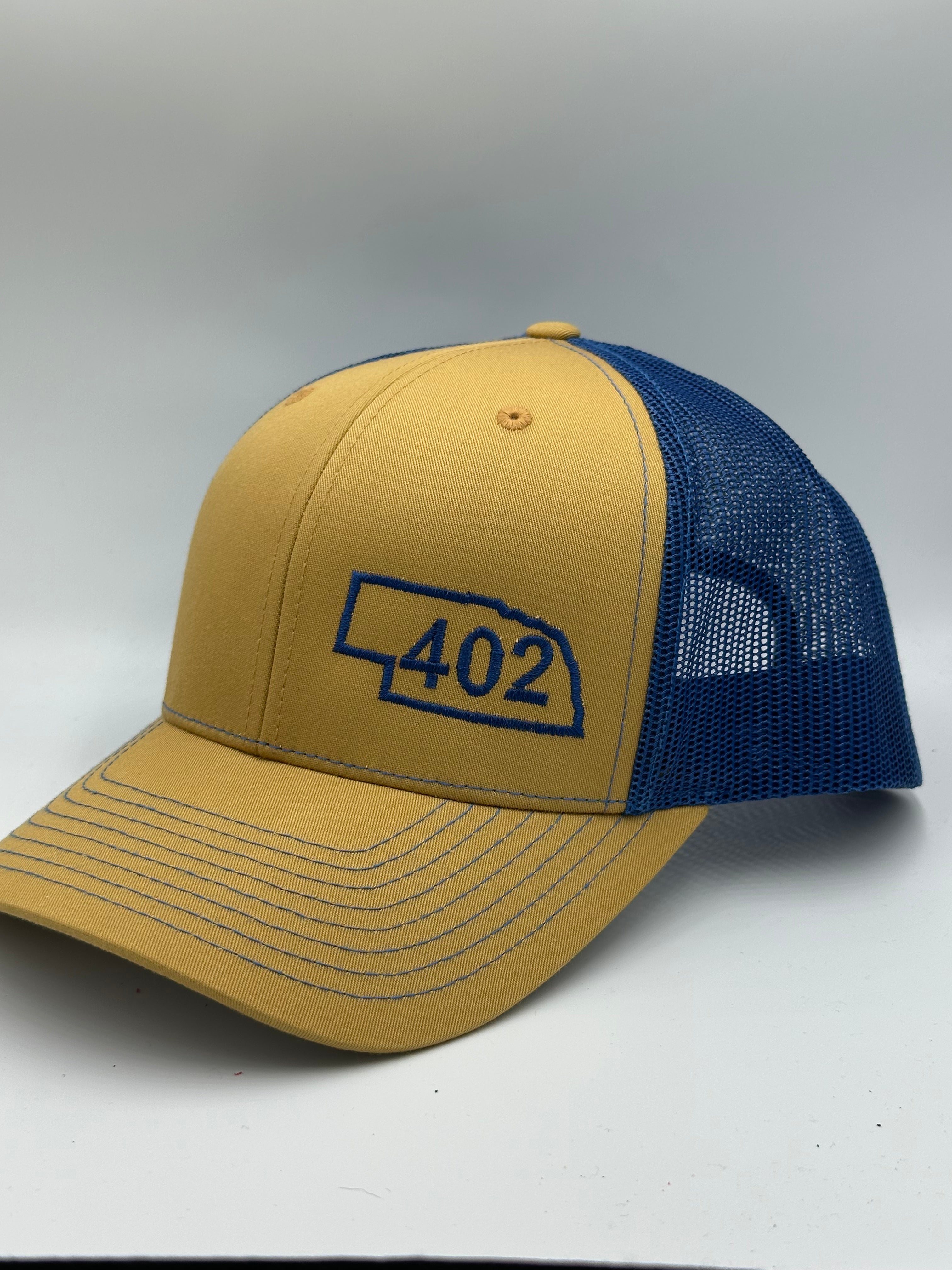 Nebraska 402 Trucker Hat Blue and Gold